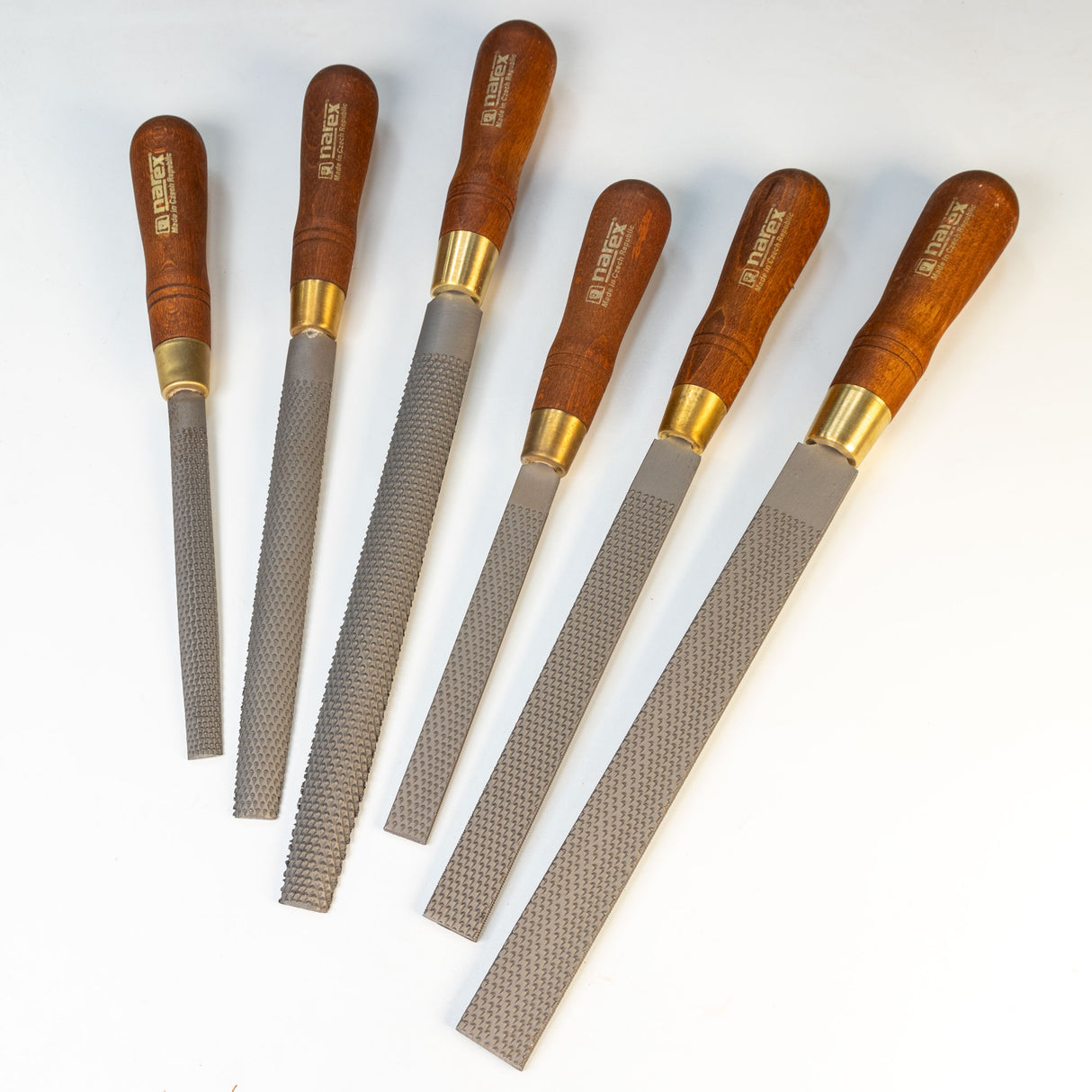 Set of six woodworking rasps with wooden handles on white background