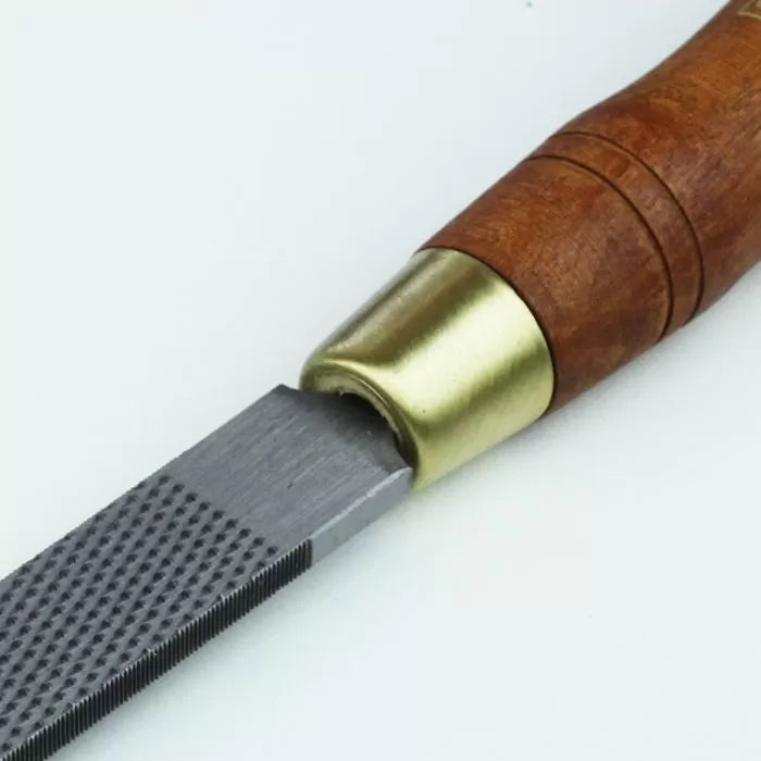 Woodworking hand rasp with steel blade and wooden handle for shaping and smoothing wood
