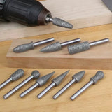 Carbide rotary burr set for woodworking, assorted shapes on wooden surface with drill