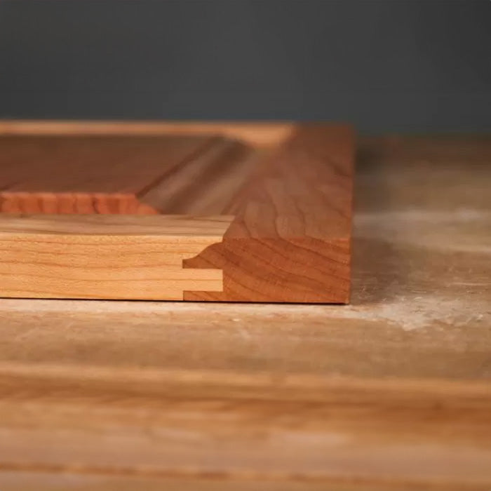 Close-up of ogee jointed wooden cabinet door edge on a workbench, woodworking detail