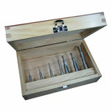 Woodworking drill bit set in open wooden case, featuring seven precision bits