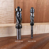 Two carbide spiral router bits for woodworking on a wooden surface, labeled item 85-940 and 85-250.