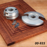 Woodworking molding cutter set with carbide inserts on a router-cut wooden panel