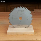 Carbide-tipped circular saw blade with 48 teeth on wooden stand, woodworking shop background