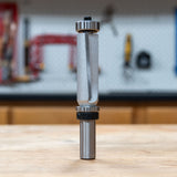 Infinity Tools double-bearing pattern router bit with downshear standing on a workbench