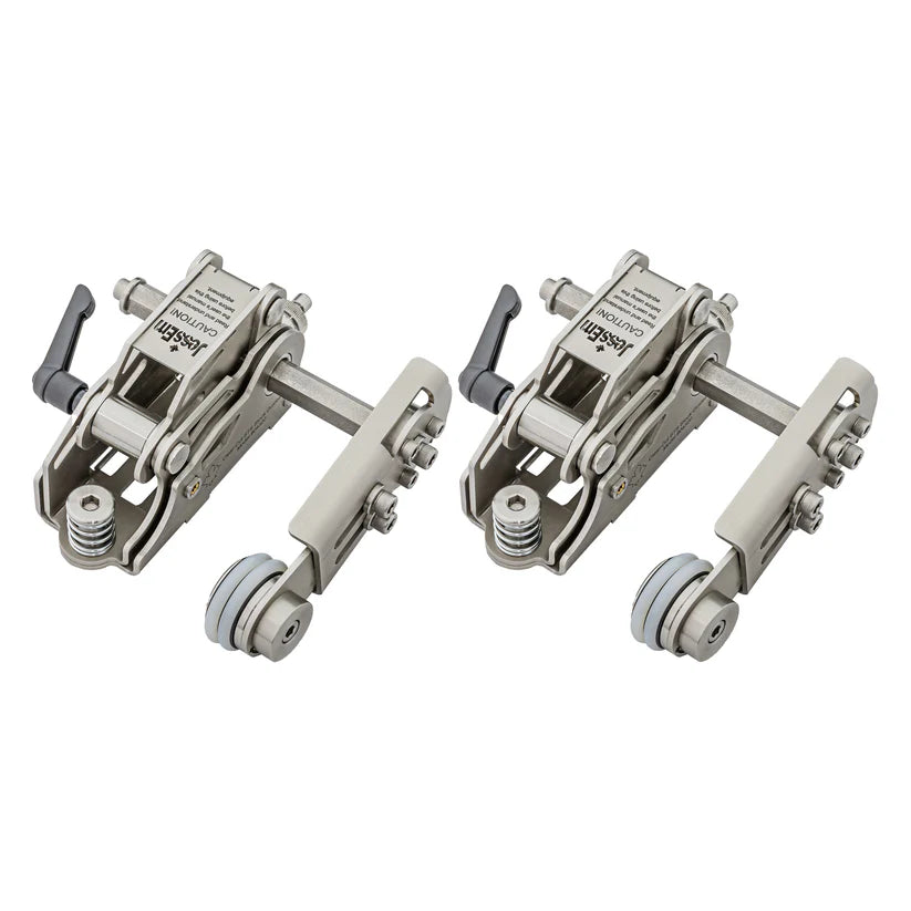 Pair of metal woodworking hold down clamps with adjustable levers and rollers on white background