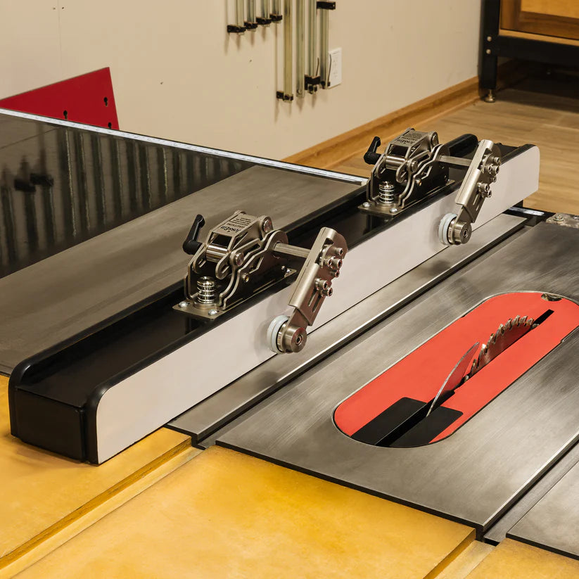 Table saw with precision fence, hold-down clamps, and saw blade in woodworking shop