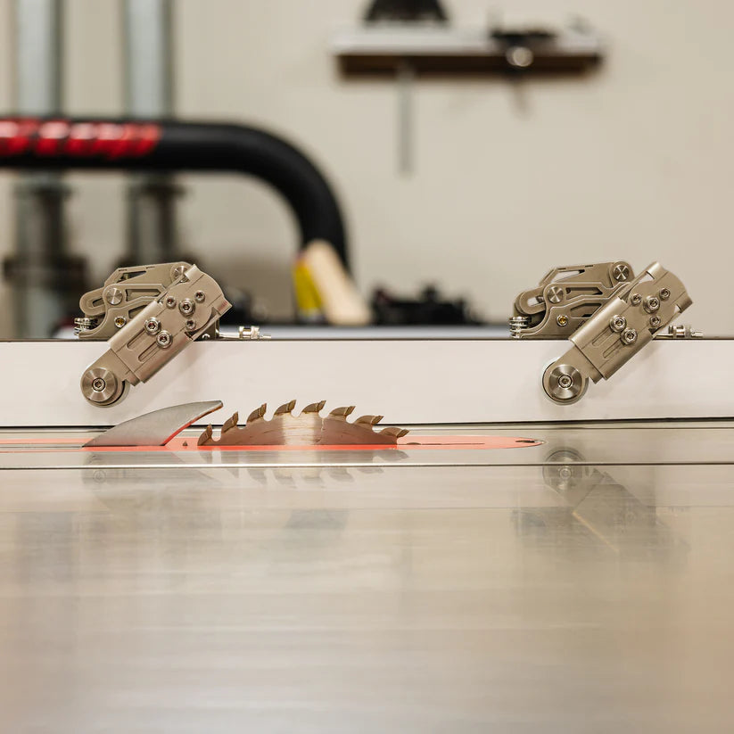 Table saw blade with featherboard attachments in a woodworking shop setting