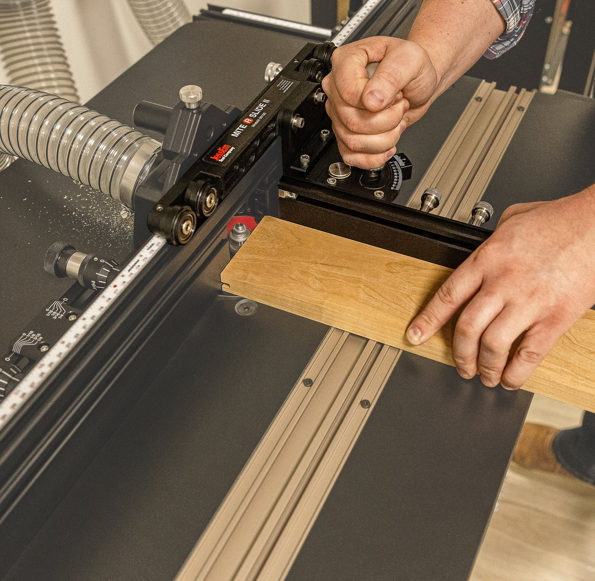 Person using a precision router table fence jig to guide wood for accurate woodworking cuts