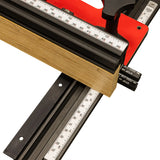 Precision woodworking stop block jig with ruler, clamp, and wood piece on T-track fence