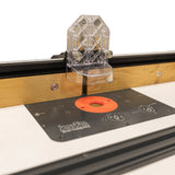 Woodworking router table with adjustable fence and clear safety guard for precise cutting