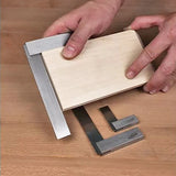 Woodworker using precision machinist squares to measure a wooden board on a workbench