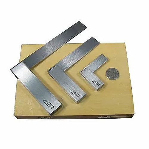 Set of three machinist squares on wooden base for precise woodworking measurements