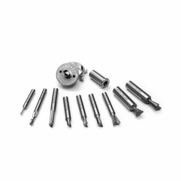 Set of precision woodworking router bits and accessories on white background