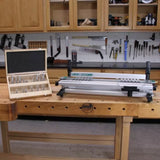 Dovetail jig and router bit set on woodworking bench in workshop