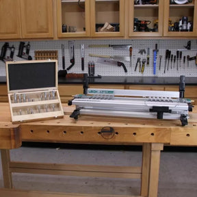 Dovetail jig and router bit set on woodworking bench in workshop