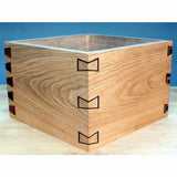 Wooden box with decorative butterfly joints, precise woodworking joinery on display.