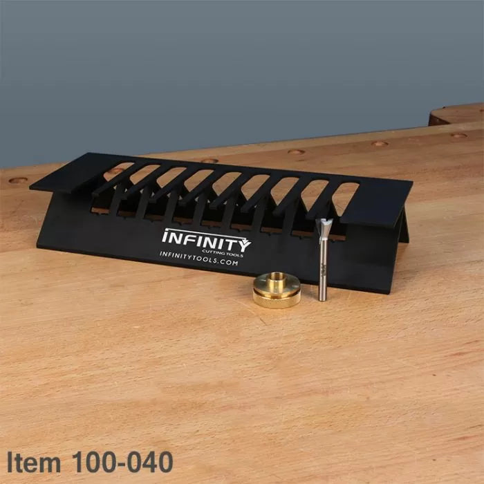 Woodworking dovetail jig, router bit, and guide bushing on a workbench