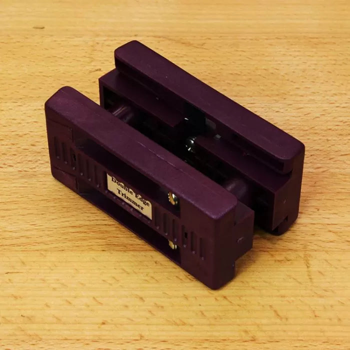 Double edge trimmer woodworking tool on a wooden surface