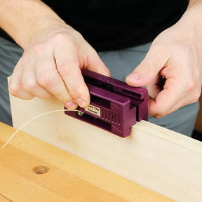 Hand using a double edge trimmer on wood panel for precise woodworking edge trimming