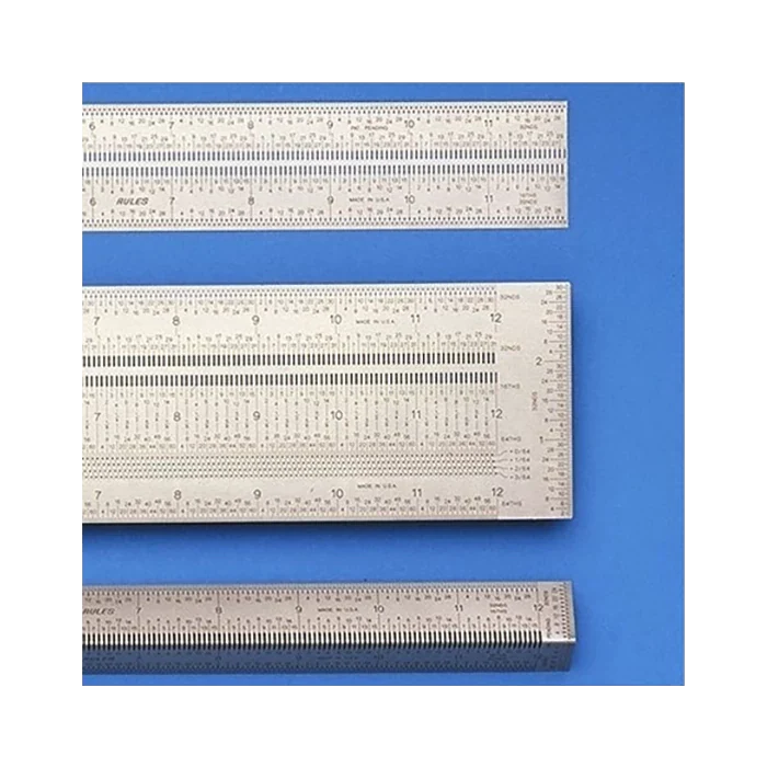 Set of precision stainless steel woodworking rulers on blue background