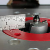 Router bit with bearing installed in router table, ruler measuring bit height, woodworking tool