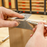 Woodworker using precision marking tool to measure and mark on woodworking project