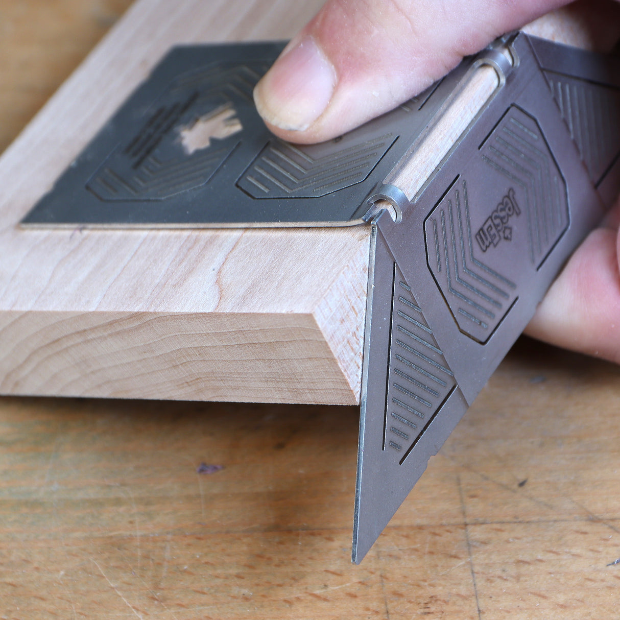Precision woodworking angle guide checking mitered wood joint for accuracy on workbench