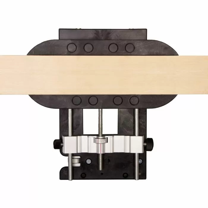 Woodworking jig securing a wooden board, viewed from above, for precise joinery tasks
