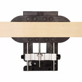 Woodworking jig securing a wooden board, viewed from above, for precise joinery tasks