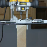 Plunge router with straight bit cutting edge on wooden board, woodworking tool setup