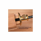 Brass woodworking depth gauge measuring groove in wood for precise measurement transfer