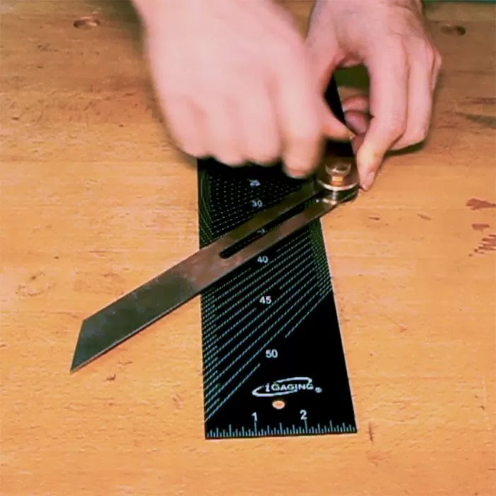 Woodworker using digital protractor bevel gauge and angle ruler on workbench