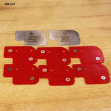 Set of red and silver 1mm magnetic shims on wood surface for woodworking tool setup