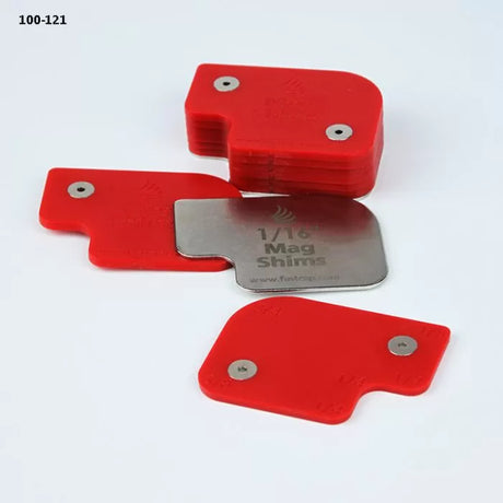 Stack of red magnetic shims and one labeled metal shim for woodworking setup