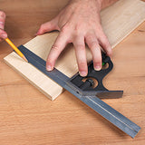 Woodworker using a combination square to mark straight lines on a wooden board