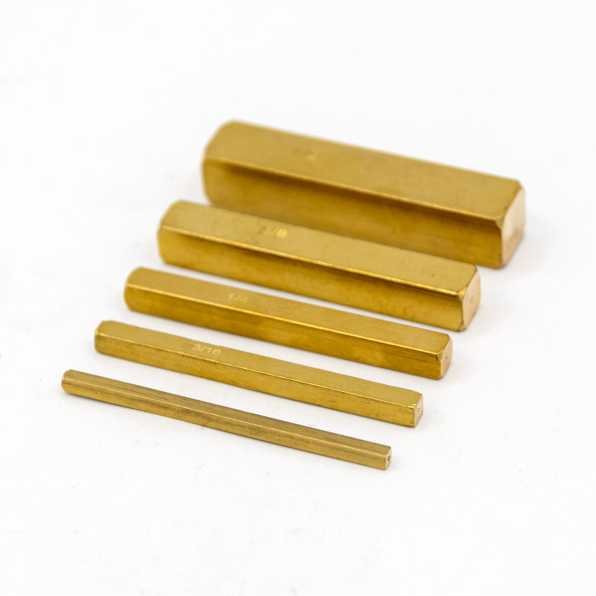 Set of brass setup bars in various sizes on a white background for woodworking precision