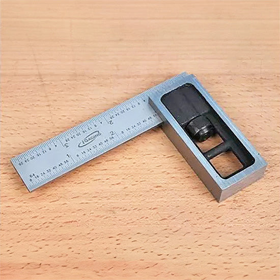 Precision woodworking combination square tool on a wooden surface