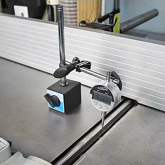 Digital dial indicator with magnetic base measuring table saw alignment in a woodworking shop