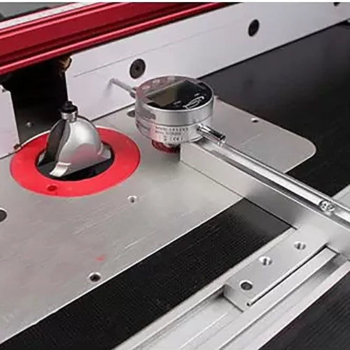 Precision dial indicator measuring router bit height on aluminum router table.