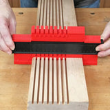 Red contour gauge measuring wood grooves for precise woodworking and joinery fitting