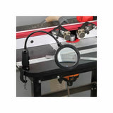 Flexible LED magnifying lamp attached to a woodworking router table
