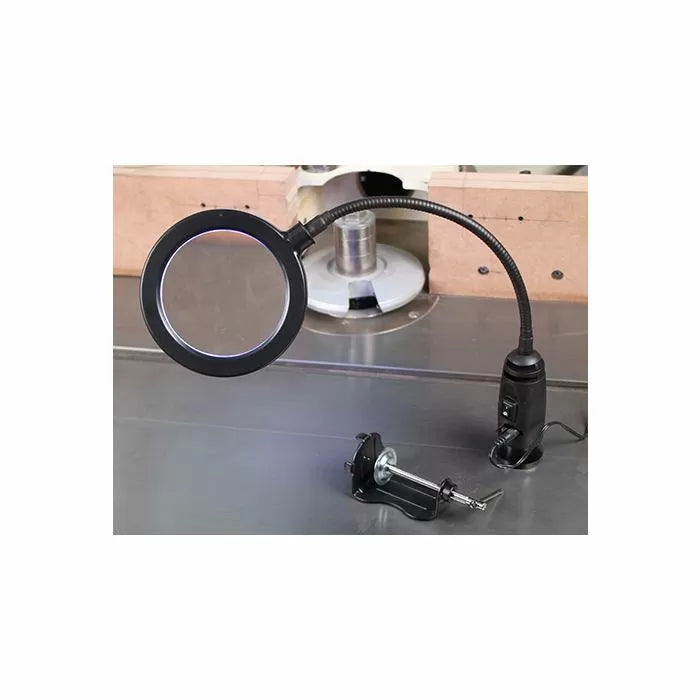 LED magnifying lamp with flexible arm and clamp set on a woodworking table