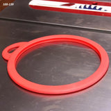 Red table saw blade gasket ring on metal saw table, woodworking tool accessory