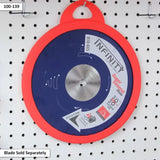 Saw blade storage case with blue and red design hanging on pegboard wall.