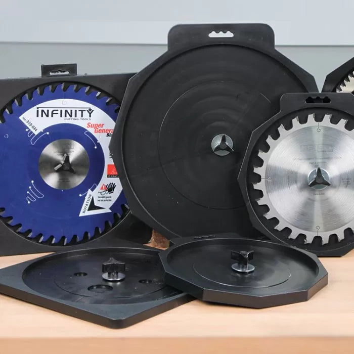 Saw blades in protective storage cases on a workbench, woodworking tool accessories.