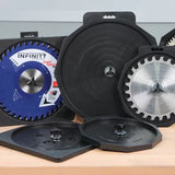 Saw blades in protective storage cases on a workbench, woodworking tool accessories.