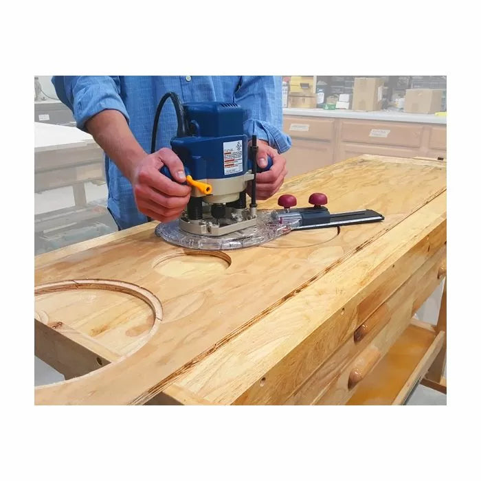 Woodworker using a router and circle cutting jig to cut precise circles in a wooden board