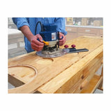 Woodworker using a router and circle cutting jig to cut precise circles in a wooden board