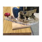 Router edge guide attachment in use on wooden board for precise woodworking cuts